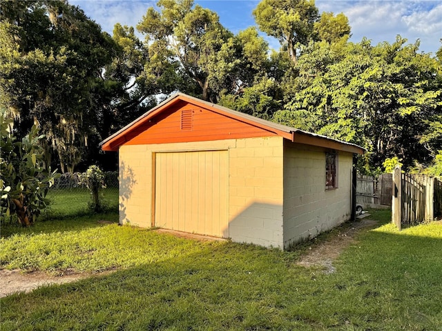 view of outdoor structure with an outbuilding and fence