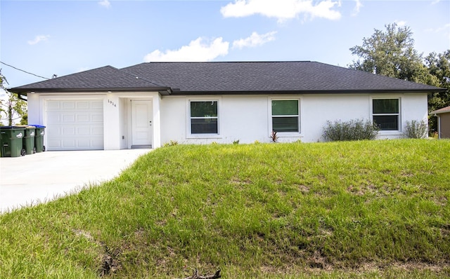 ranch-style house with a garage and a front lawn