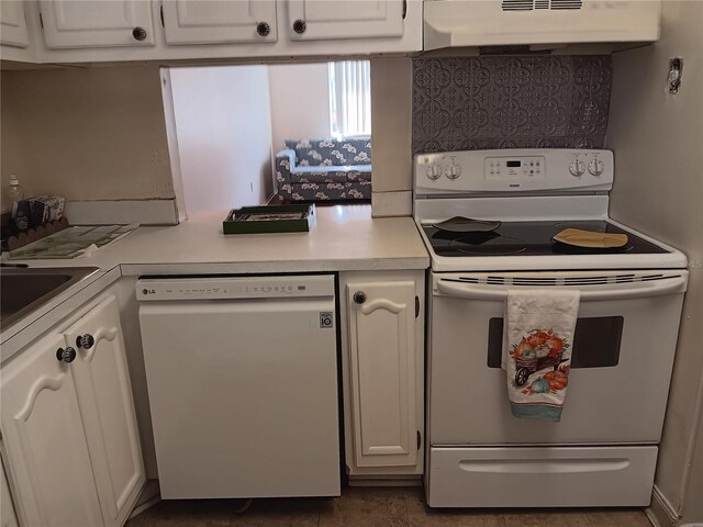 kitchen featuring wall chimney exhaust hood, tile patterned floors, white cabinetry, and white appliances