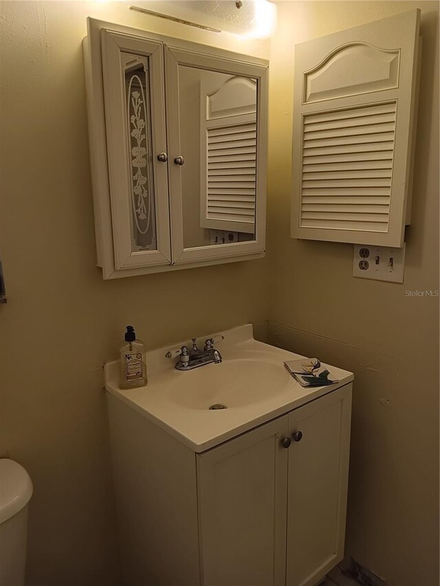 bathroom featuring toilet and vanity