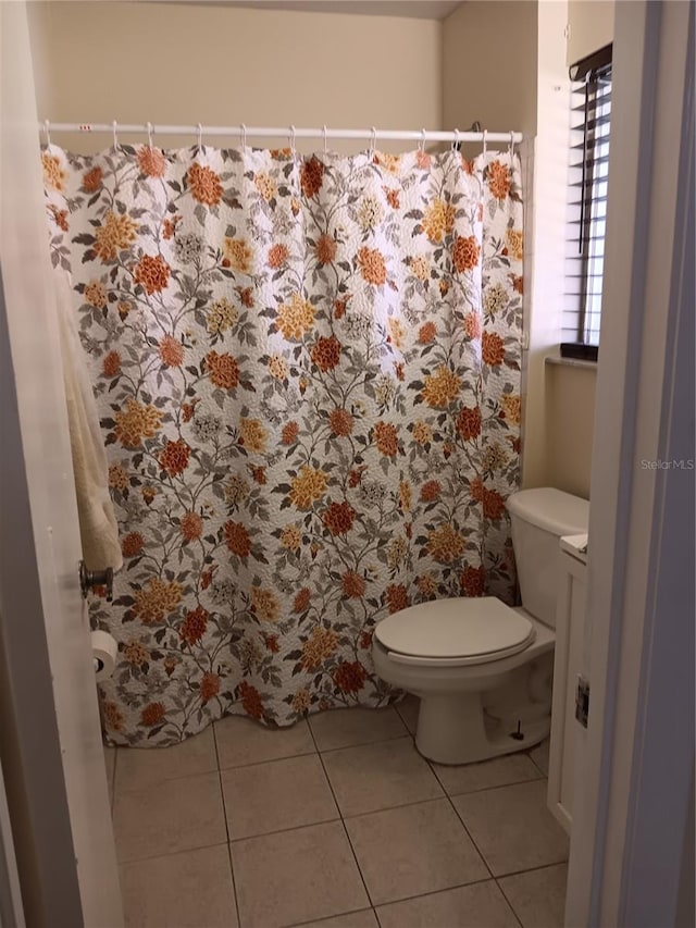 bathroom with tile patterned floors and toilet