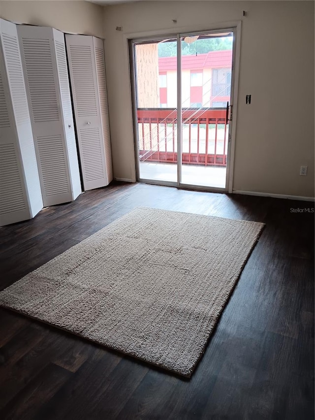 unfurnished room with baseboards and wood finished floors