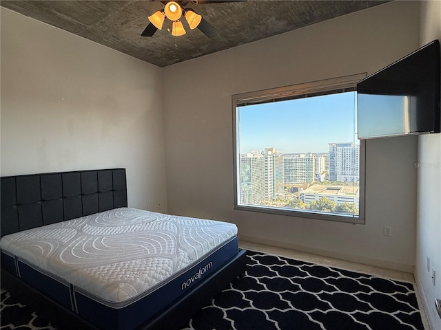 bedroom featuring ceiling fan and carpet