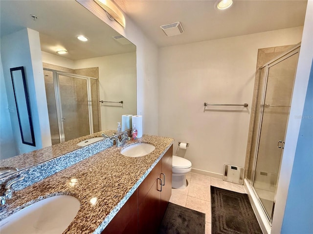 bathroom with tile patterned flooring, vanity, toilet, and walk in shower