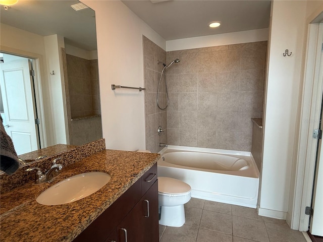 full bathroom featuring toilet, tile patterned flooring, vanity, and tiled shower / bath