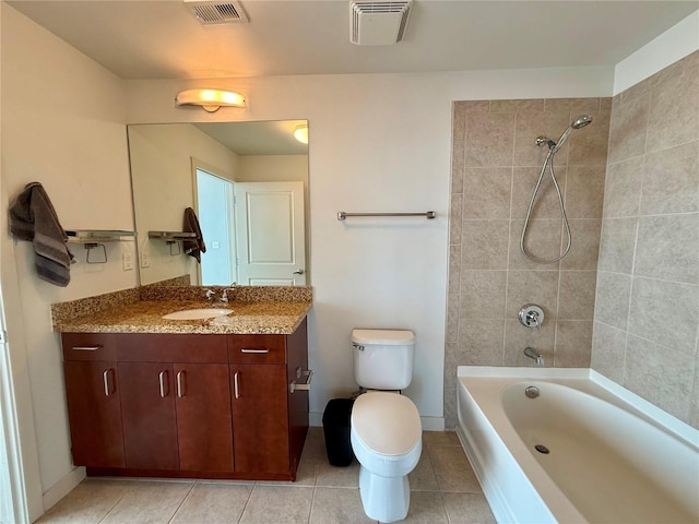 full bathroom featuring tile patterned floors, vanity, toilet, and tiled shower / bath