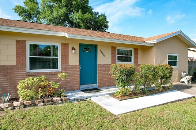 ranch-style home with a front lawn