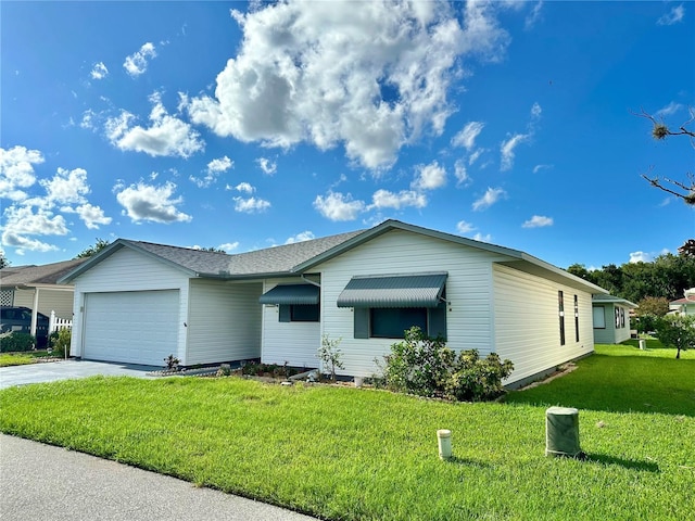 view of front of property with a garage, a front yard, and concrete driveway