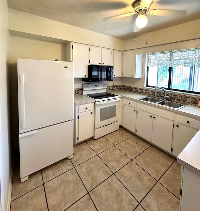 kitchen with light tile patterned floors, white appliances, a sink, white cabinets, and light countertops