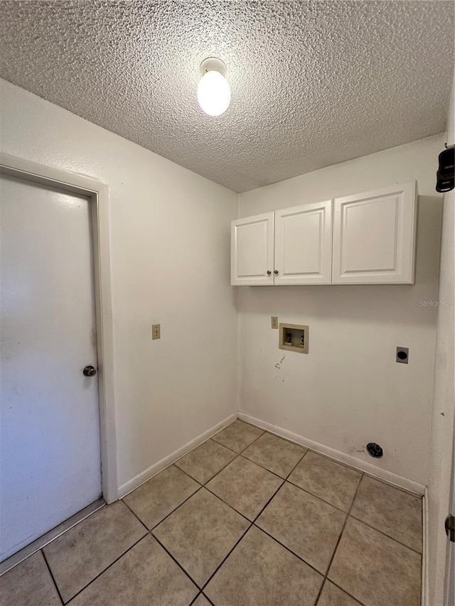 washroom with cabinet space, baseboards, washer hookup, electric dryer hookup, and light tile patterned flooring