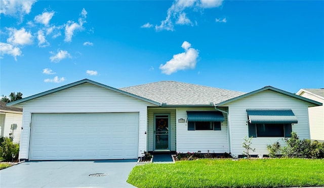 single story home featuring a garage and a front lawn