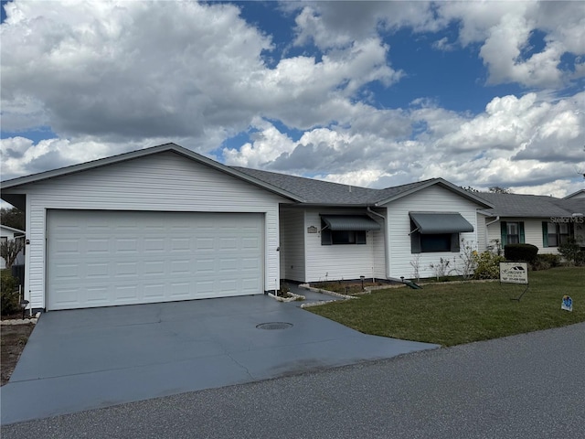 single story home with a shingled roof, concrete driveway, an attached garage, and a front lawn