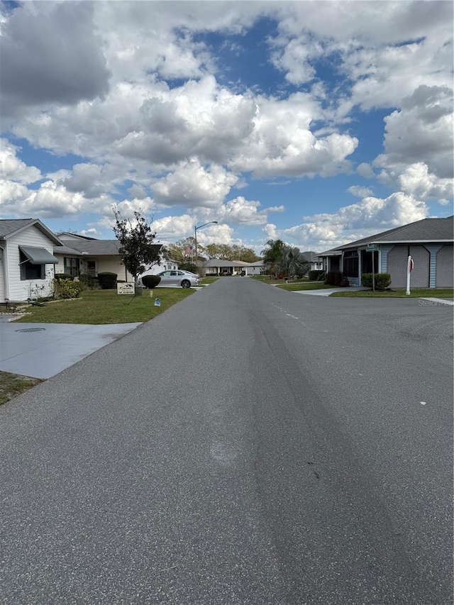 view of street with a residential view and street lights