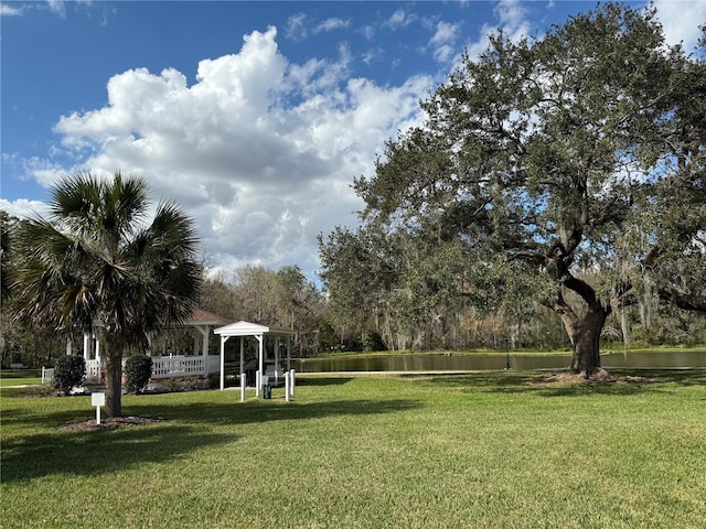 view of community featuring a water view, a yard, and a gazebo