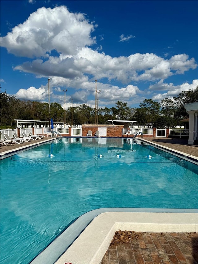 community pool featuring fence