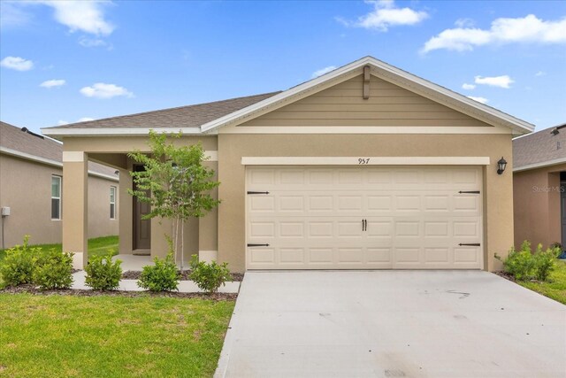 ranch-style home featuring a front lawn and a garage