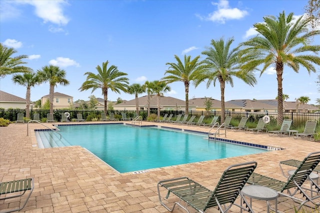 pool featuring a patio area and fence