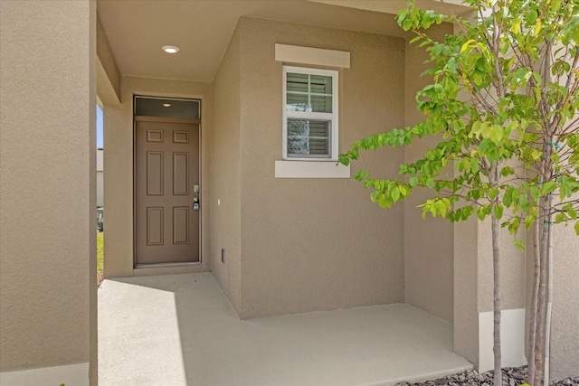 entrance to property with stucco siding