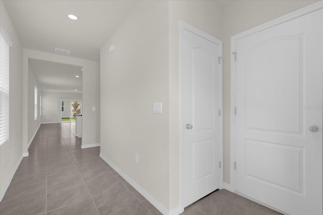 corridor featuring recessed lighting, tile patterned flooring, visible vents, and baseboards