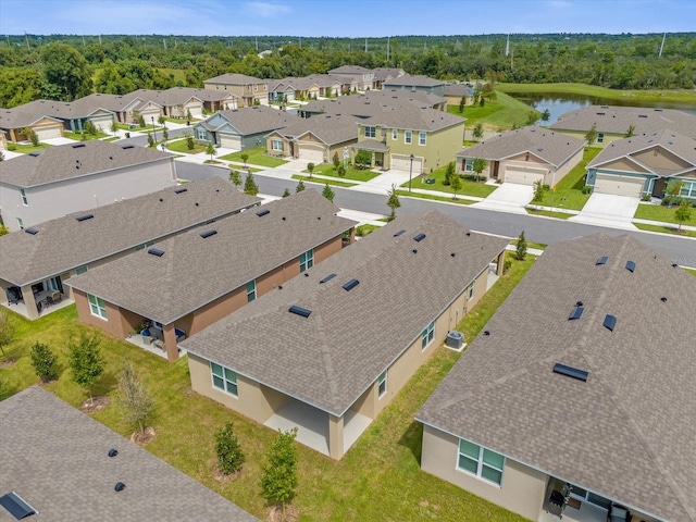 bird's eye view with a water view and a residential view