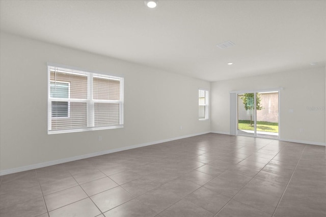 spare room with recessed lighting, baseboards, and tile patterned floors