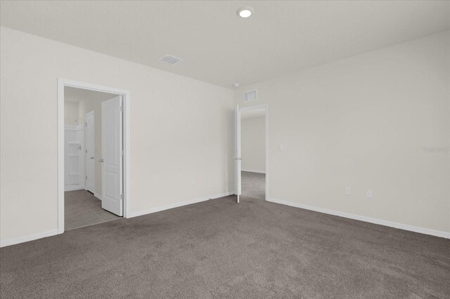 carpeted empty room with baseboards and visible vents