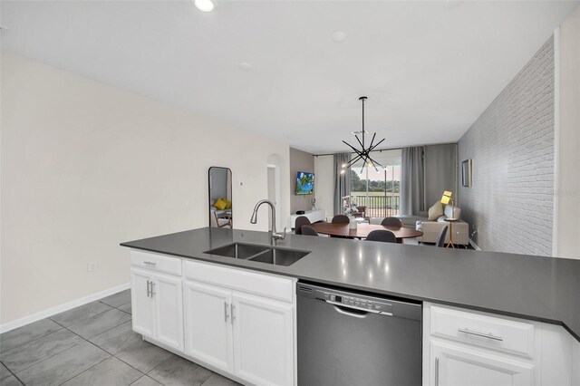 kitchen featuring an inviting chandelier, dishwasher, hanging light fixtures, light tile patterned floors, and sink