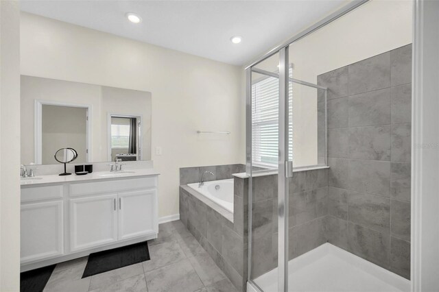 bathroom with double sink vanity, plus walk in shower, and tile patterned flooring