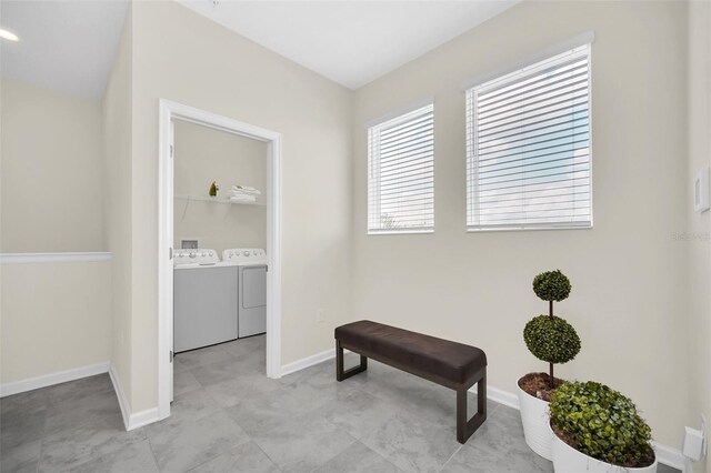 sitting room with light tile patterned floors and washer and clothes dryer