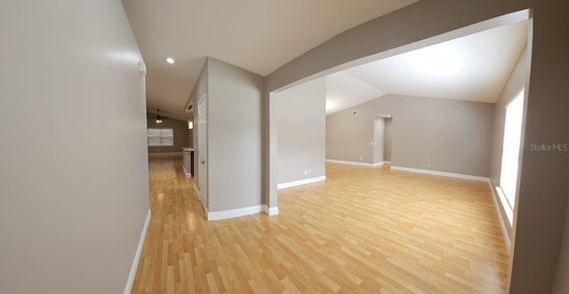 interior space with light wood-type flooring and lofted ceiling