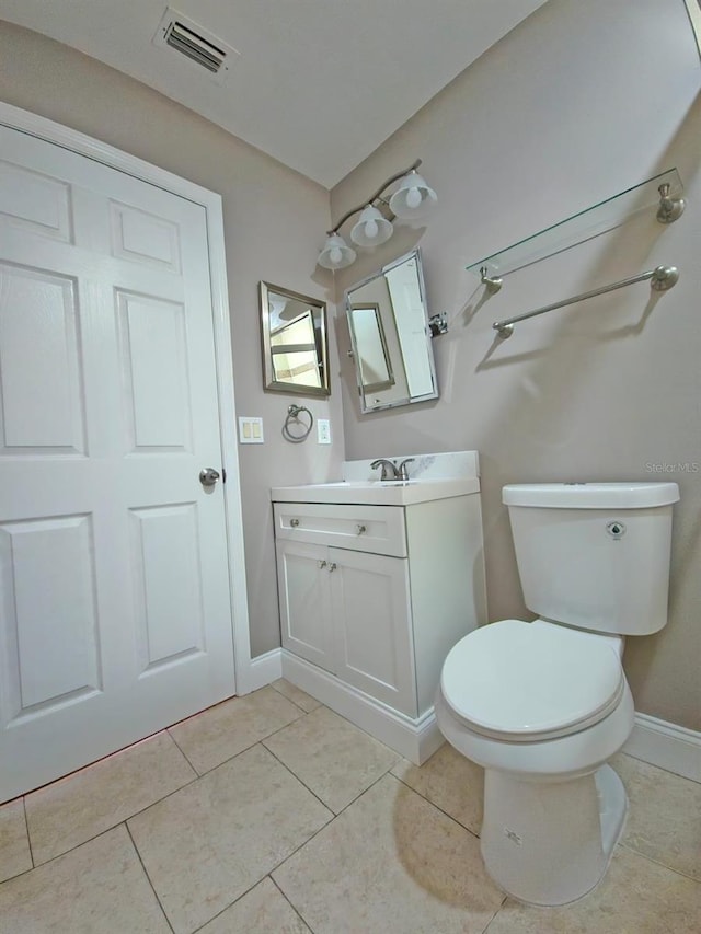 bathroom featuring vanity, toilet, and tile patterned floors