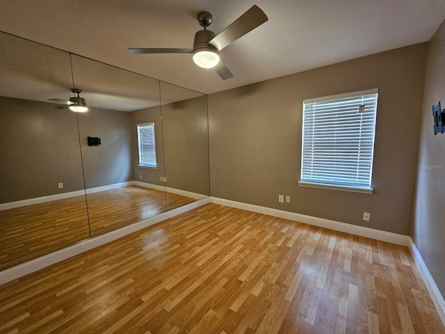 spare room with light hardwood / wood-style floors and ceiling fan