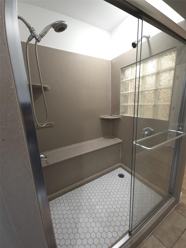 bathroom with walk in shower and tile patterned flooring