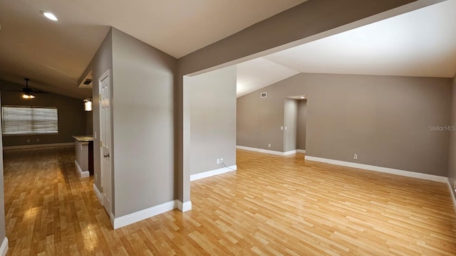 unfurnished room with light hardwood / wood-style floors, ceiling fan, and vaulted ceiling