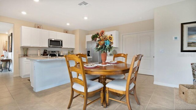 dining area featuring light tile patterned floors