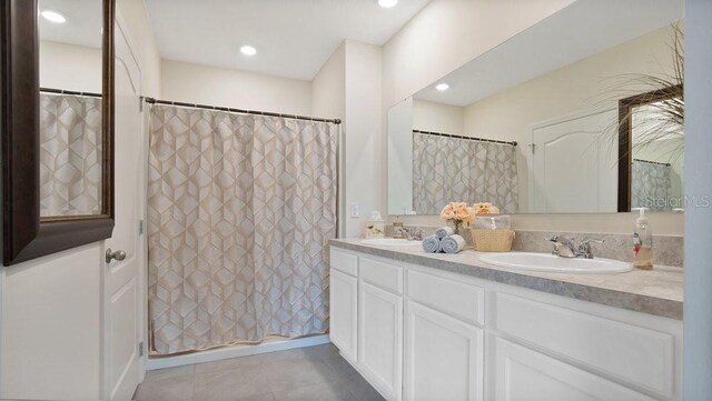 bathroom with vanity, a shower with shower curtain, and tile patterned flooring