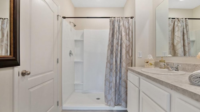 bathroom with curtained shower and vanity