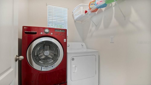 washroom featuring washing machine and dryer