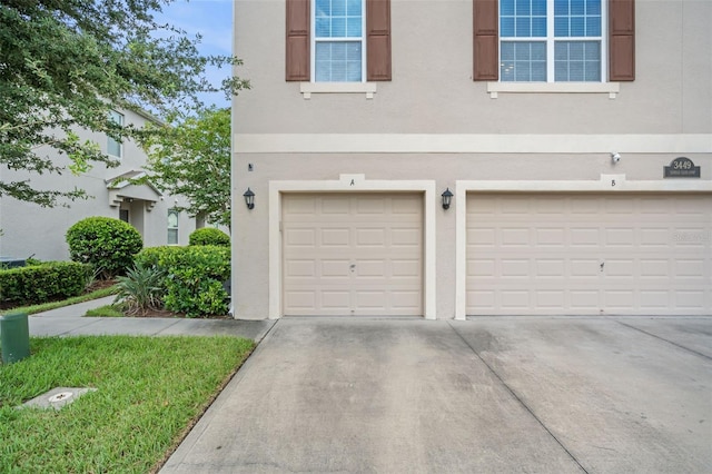 garage featuring concrete driveway