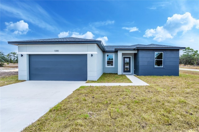 view of front of property with a front lawn and a garage