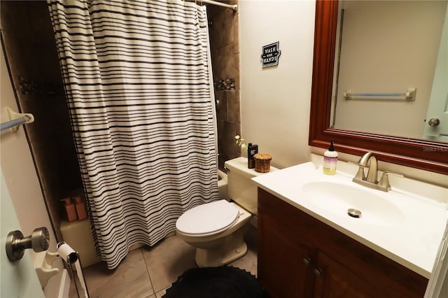 bathroom featuring tile patterned flooring, vanity, and toilet