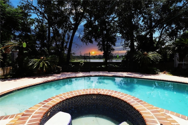 view of pool at dusk