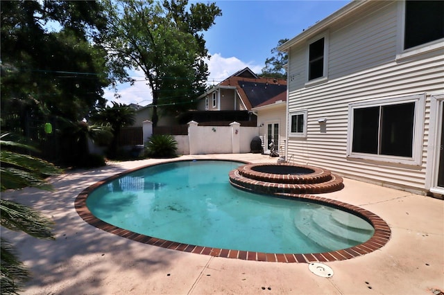 view of pool with a patio area, an in ground hot tub, and french doors