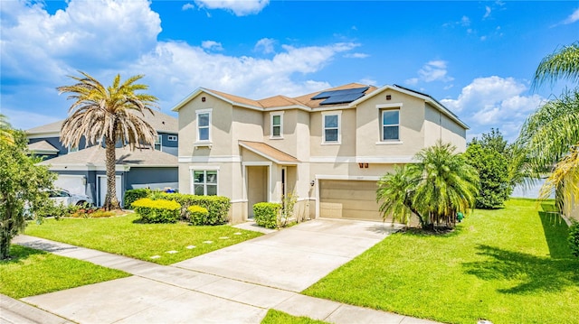 mediterranean / spanish-style home with a front lawn, solar panels, and a garage