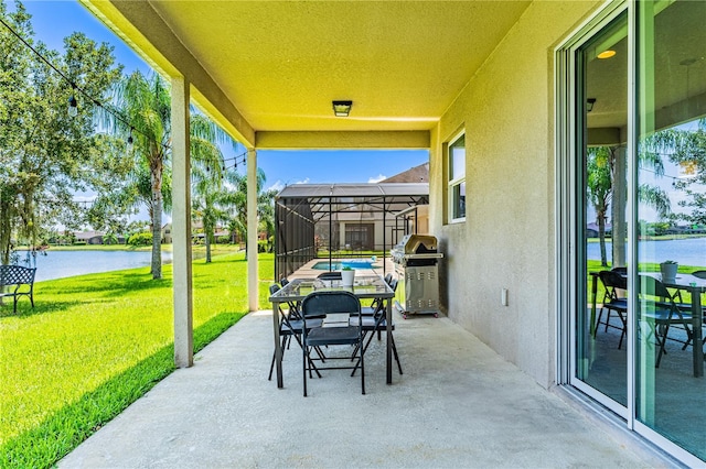 view of patio / terrace featuring glass enclosure, a water view, and area for grilling