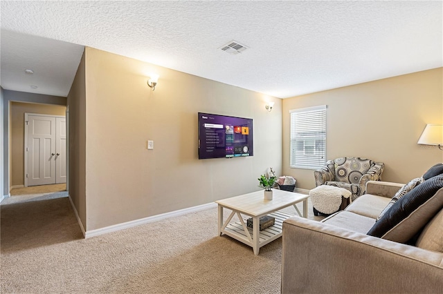 carpeted living room with a textured ceiling