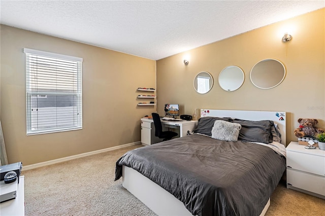 bedroom featuring a textured ceiling and light carpet