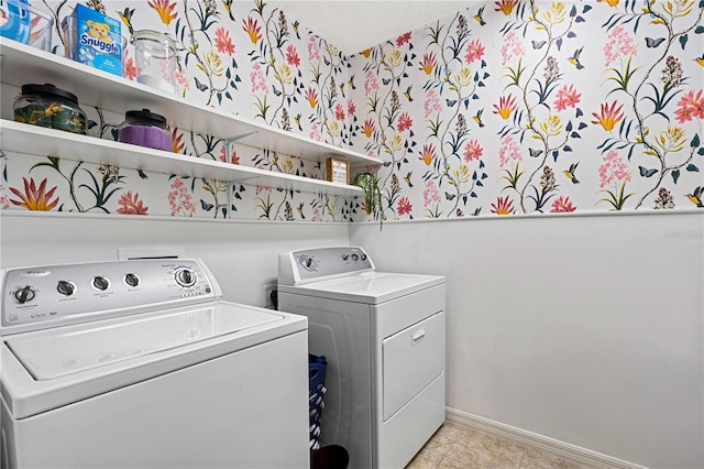 laundry room with light tile patterned floors and washing machine and clothes dryer