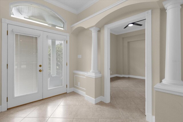 tiled foyer with crown molding, decorative columns, ceiling fan, and french doors