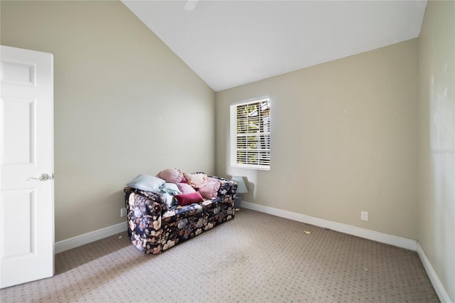 sitting room with light carpet, baseboards, and vaulted ceiling